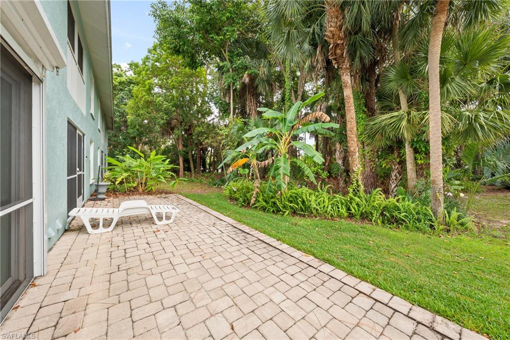 Paved patio area featuring light-colored pavers in a herringbone pattern