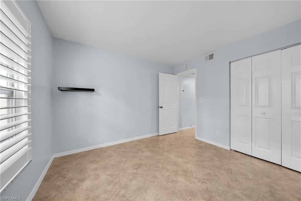 Interior room featuring light blue walls and wood-finish flooring