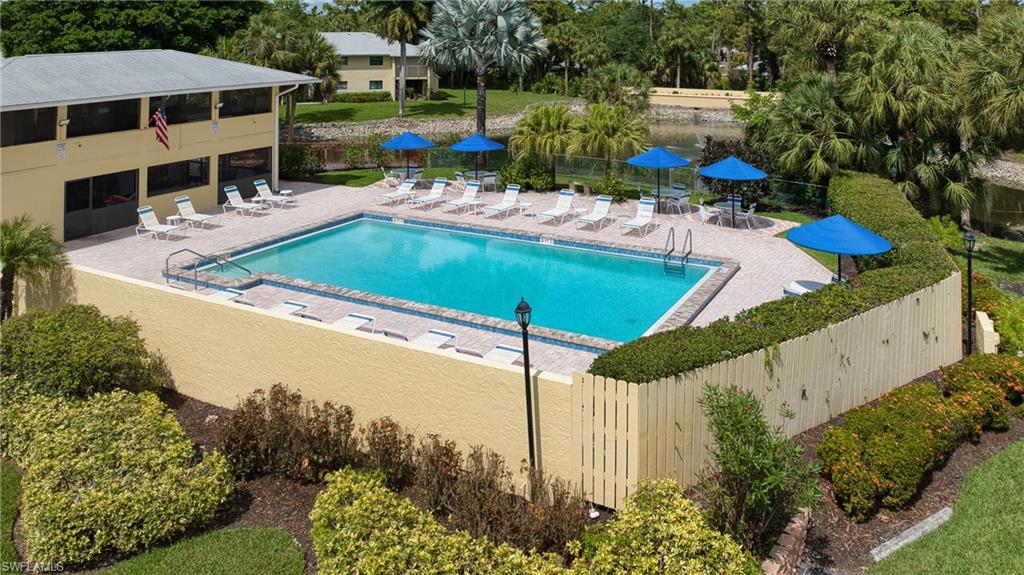 Rectangular swimming pool with a tile border and paver surround
