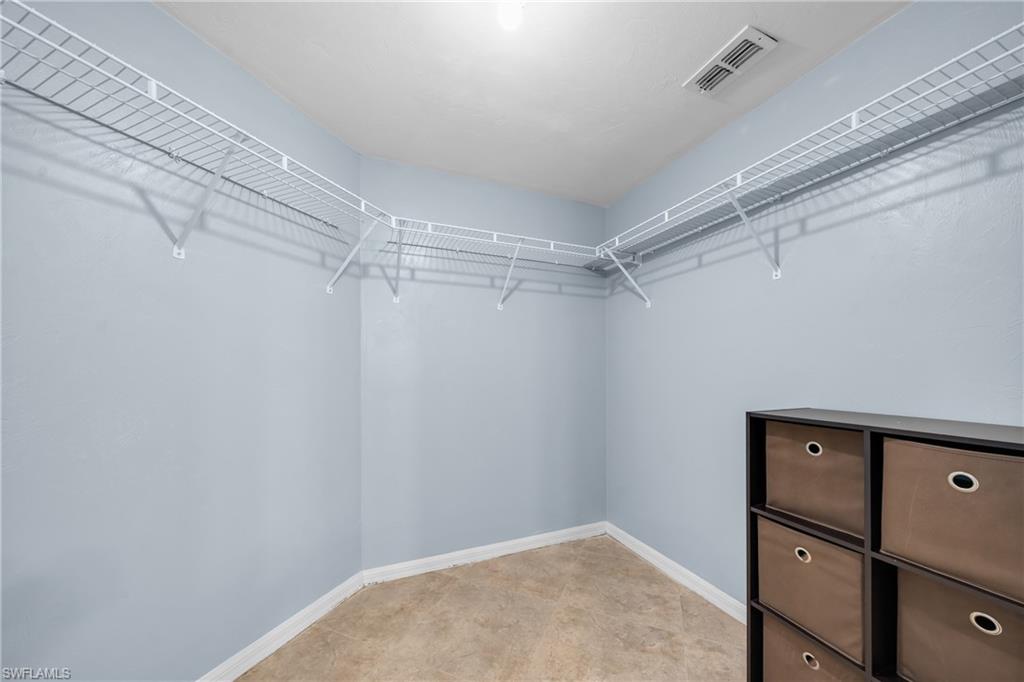 Spacious walk-in closet featuring light blue walls and wire shelving system