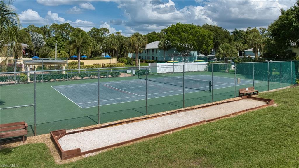 Tennis courts with chain-link fencing, a bocce ball court, and surrounding green space