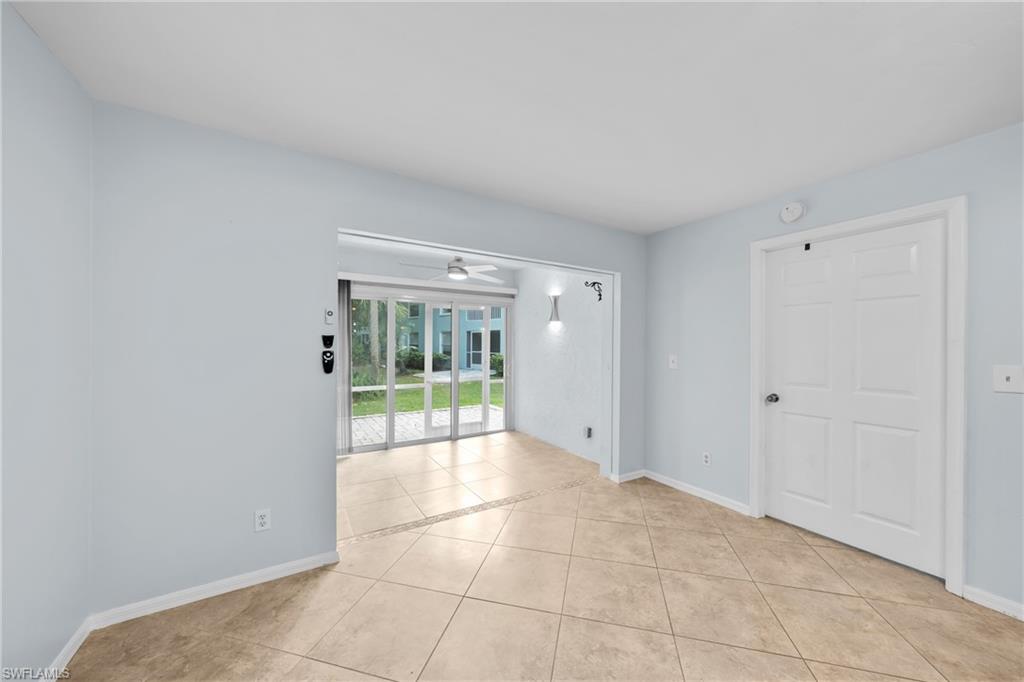 Tiled flooring extending into a screened-in patio with sliding glass doors