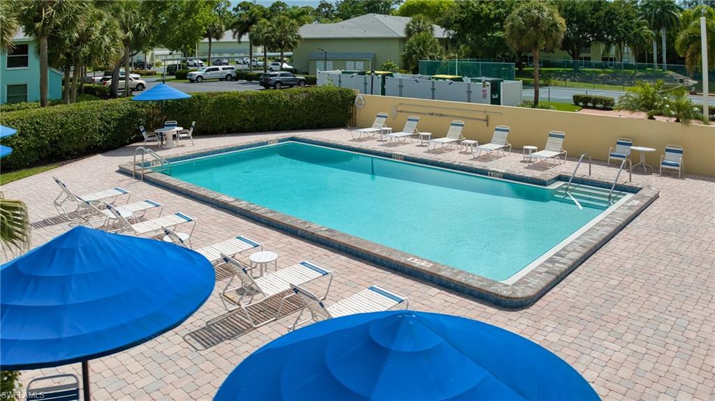 Rectangular swimming pool with integrated steps, surrounded by a paver deck