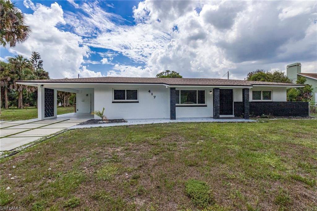 White stucco exterior with dark gray stone veneer accents