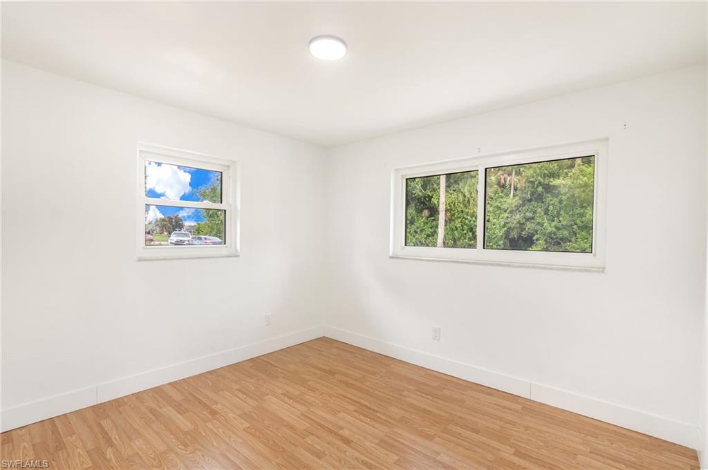 Room featuring light wood-finish flooring and white baseboards