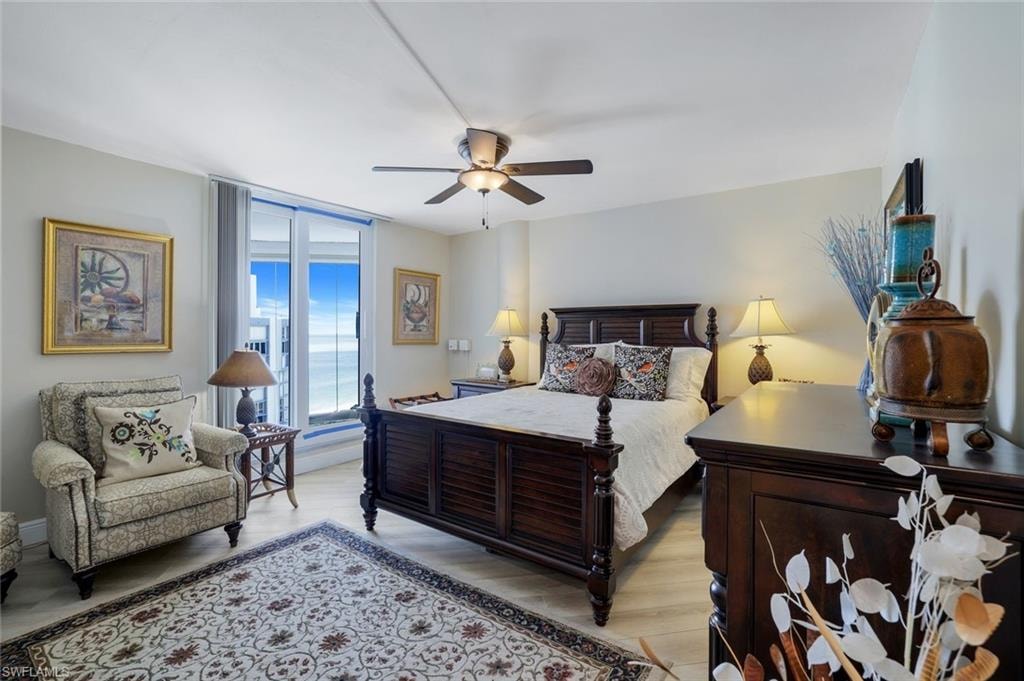 Bedroom with a ceiling fan, light wood-type flooring, and access to outside