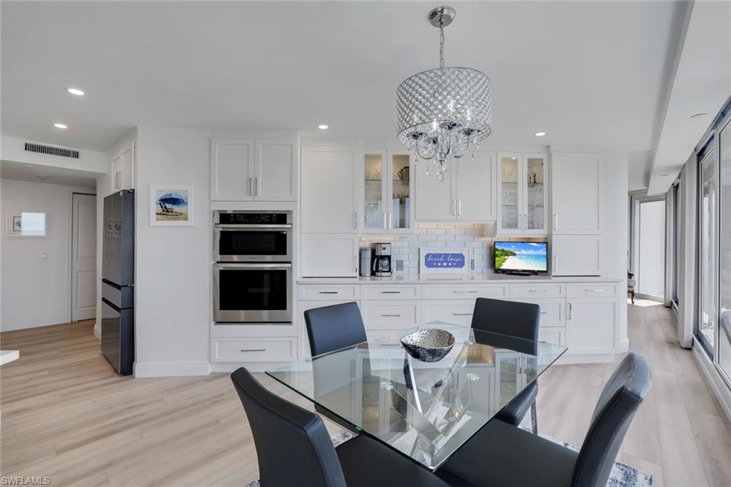 Dining space featuring a chandelier, recessed lighting, light wood finished floors, and baseboards