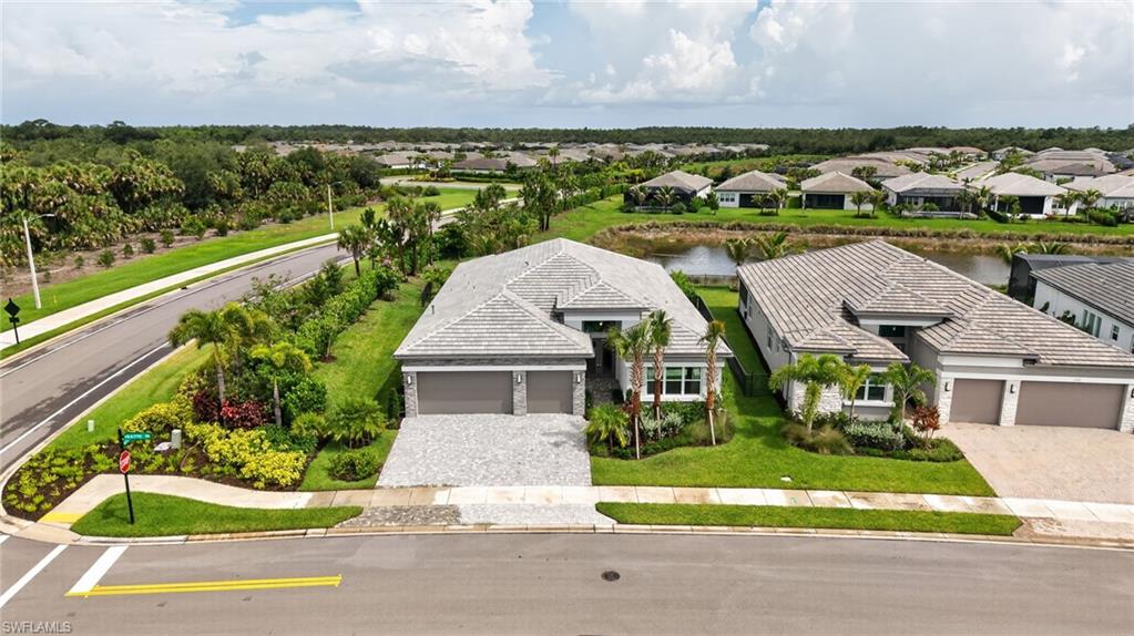 Contemporary single-story residence with a gray tile roof and stone façade accents