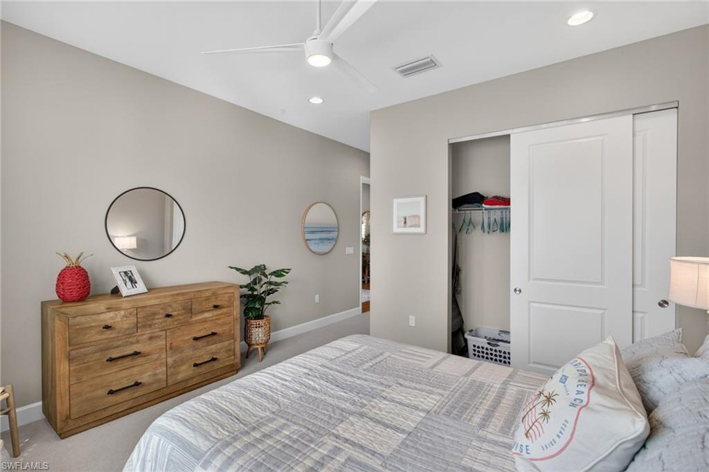 Neutral-toned bedroom featuring recessed lighting and a ceiling fan