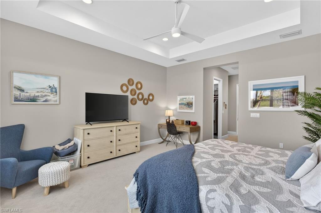 Neutral-toned interior with a tray ceiling and recessed lighting