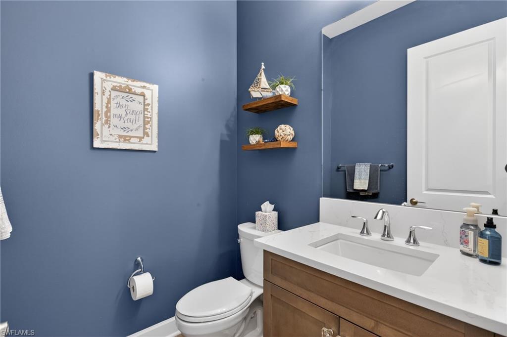 Vanity featuring a chrome faucet, integrated rectangular sink, and light-toned countertop
