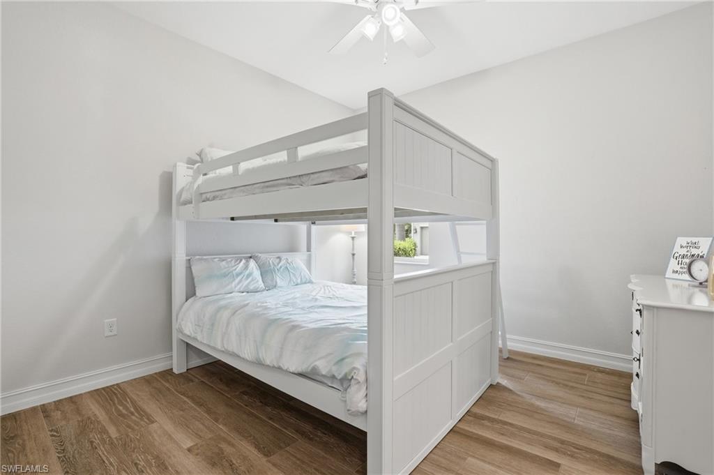Bright room with vaulted ceiling and wood-finish flooring