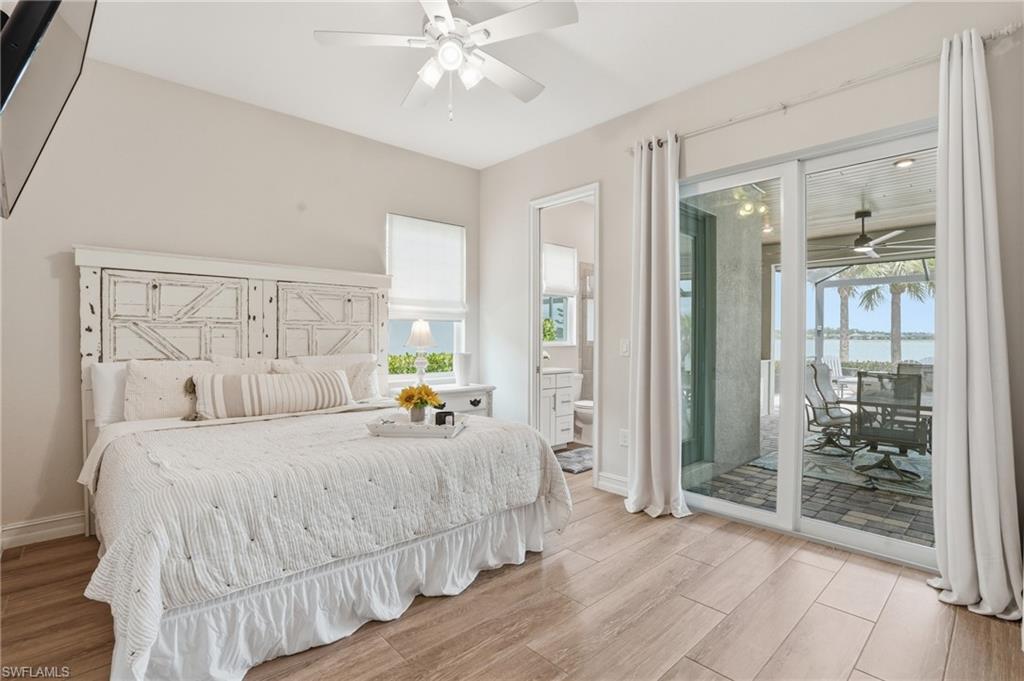 Spacious room featuring wood-finish flooring, a ceiling fan, and sliding glass doors opening to a covered patio