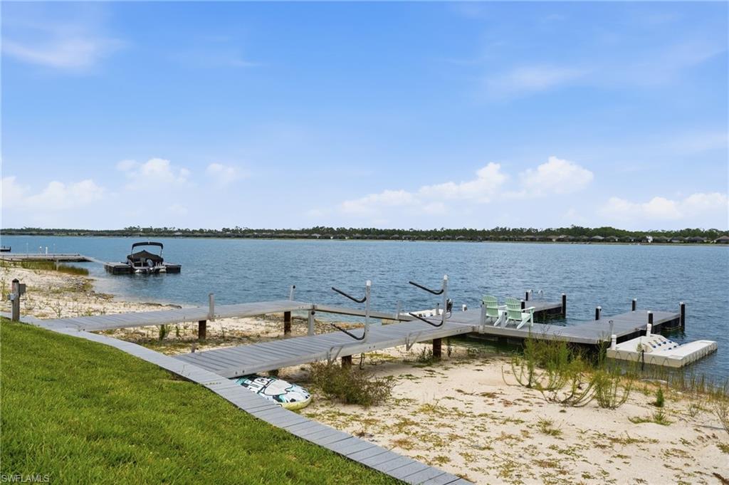 Waterfront property featuring a private dock system, direct water access, and a sandy shoreline