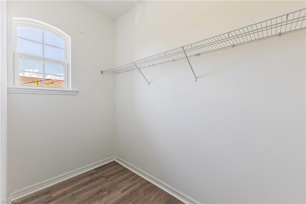 Walk in closet featuring wood finished floors