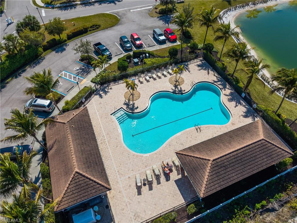 Community pool with a water view and a patio area