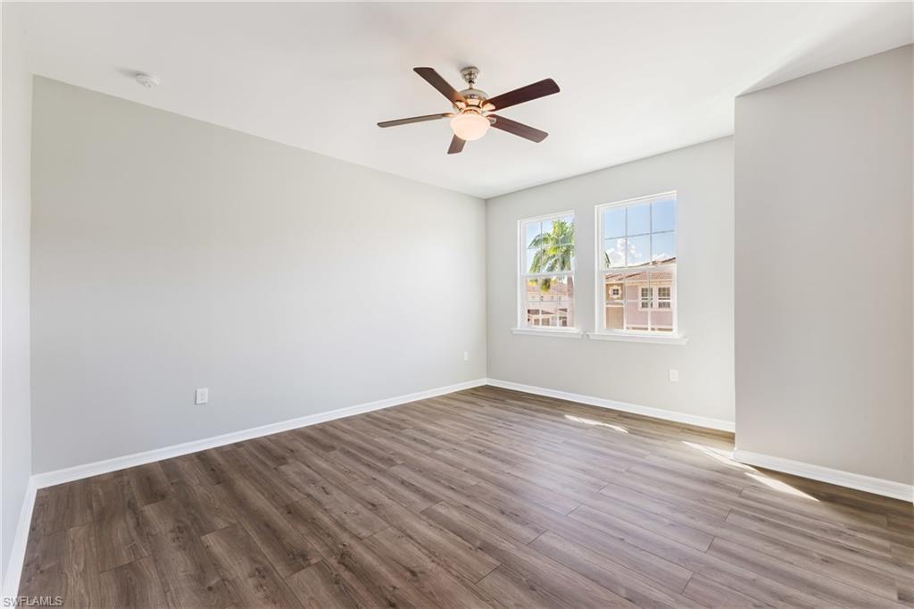 Unfurnished room featuring light wood-style floors and ceiling fan