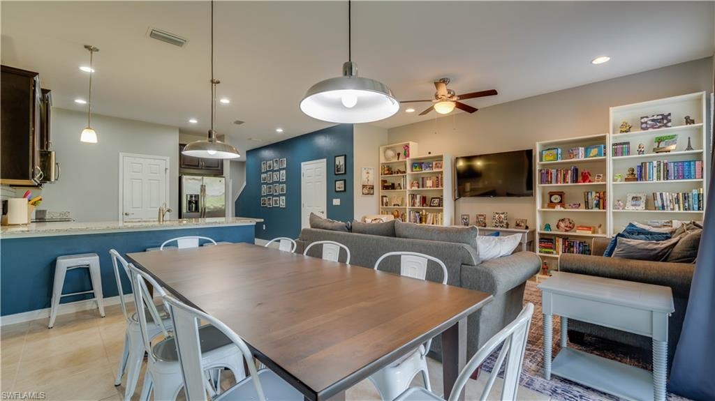 Tiled dining area featuring ceiling fan