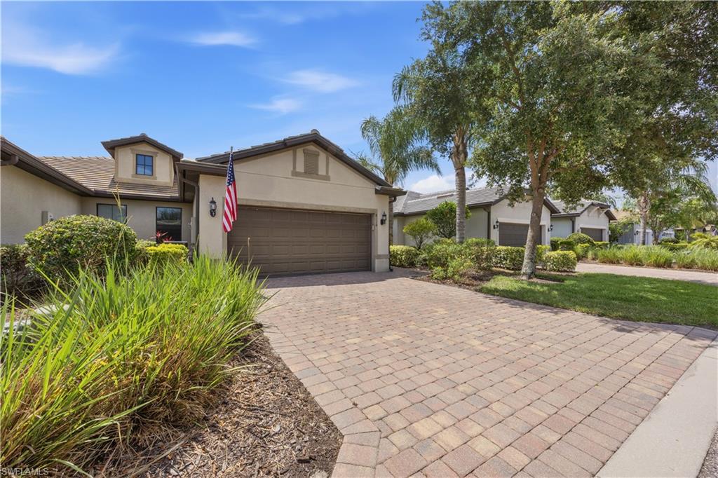 Stucco exterior with a tiled roof and paved driveway