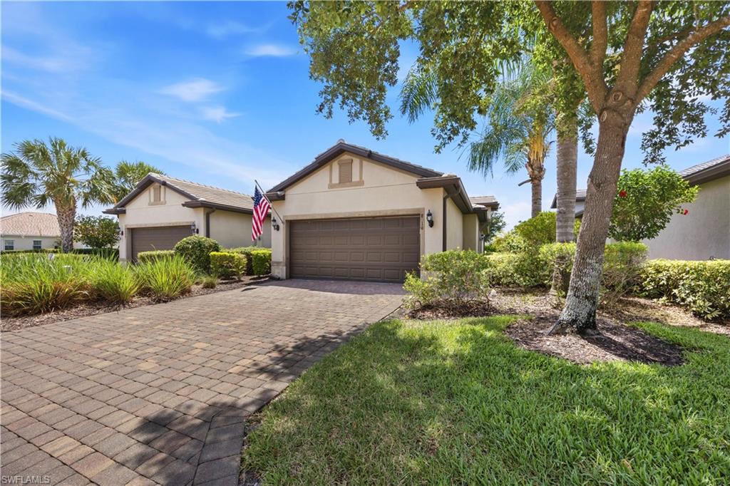 Stucco exterior with a tiled roof and paved driveway