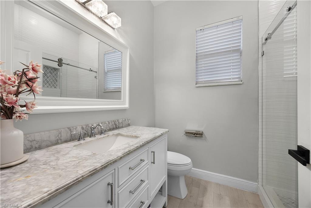 Bathroom featuring a white vanity with a marble countertop