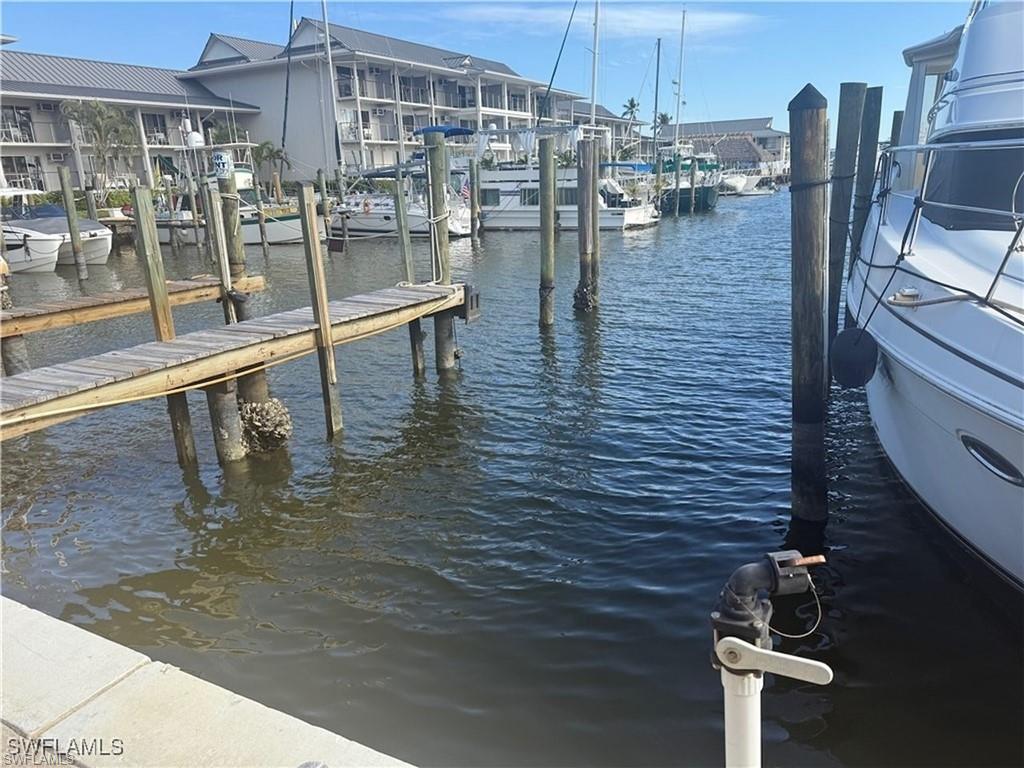 Private dock access featuring a wooden walkway and pilings
