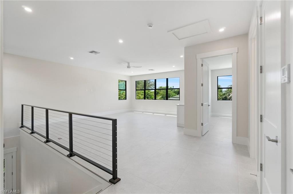 Corridor featuring recessed lighting and attic access