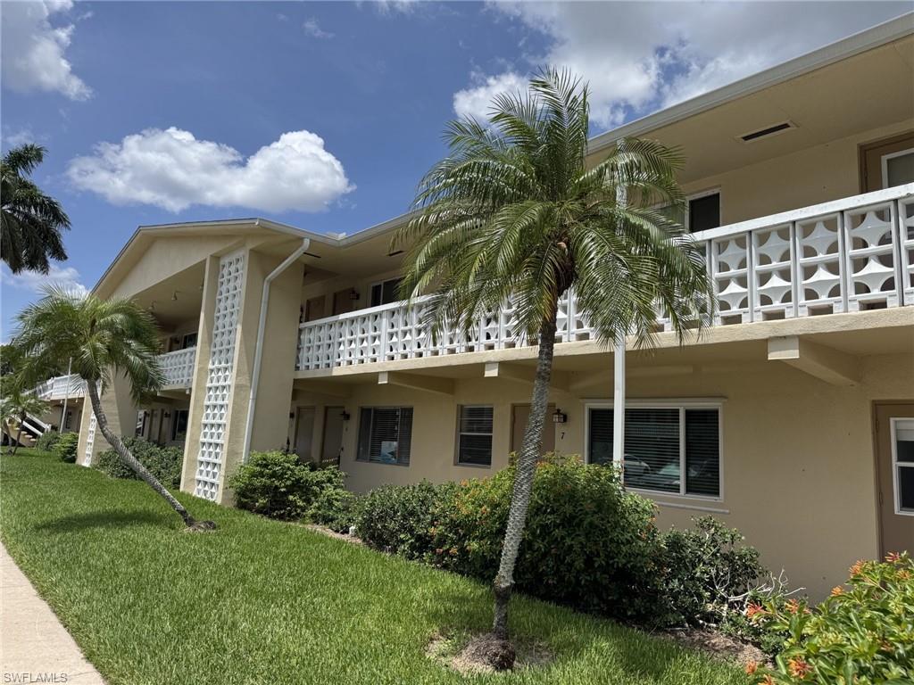 Notice the new hurricane impact windows and the front door to the living room and a second front door to the kitchen. The front of the building has a beautiful art deco vibe.