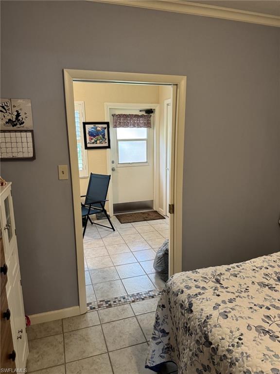 View of the guest bedroom to the sunroom and back door.  There is a second closet for each bedroom to use, giving both bedrooms two closets.