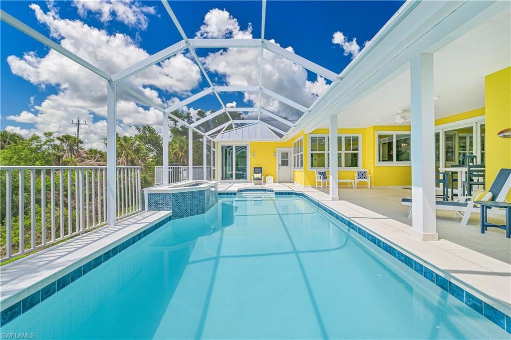 Screened outdoor pool with integrated spa and surrounding deck