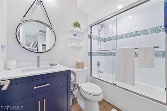 Bathroom featuring a navy blue vanity with a white countertop and undermount sink, brushed nickel faucet, and a circular mirror with rope detailing
