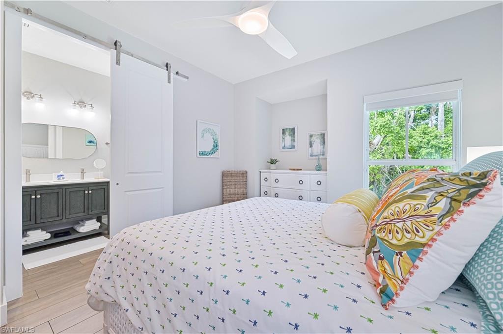 Spacious room featuring a contemporary ceiling fan, an expansive window, and a white dresser with circular hardware