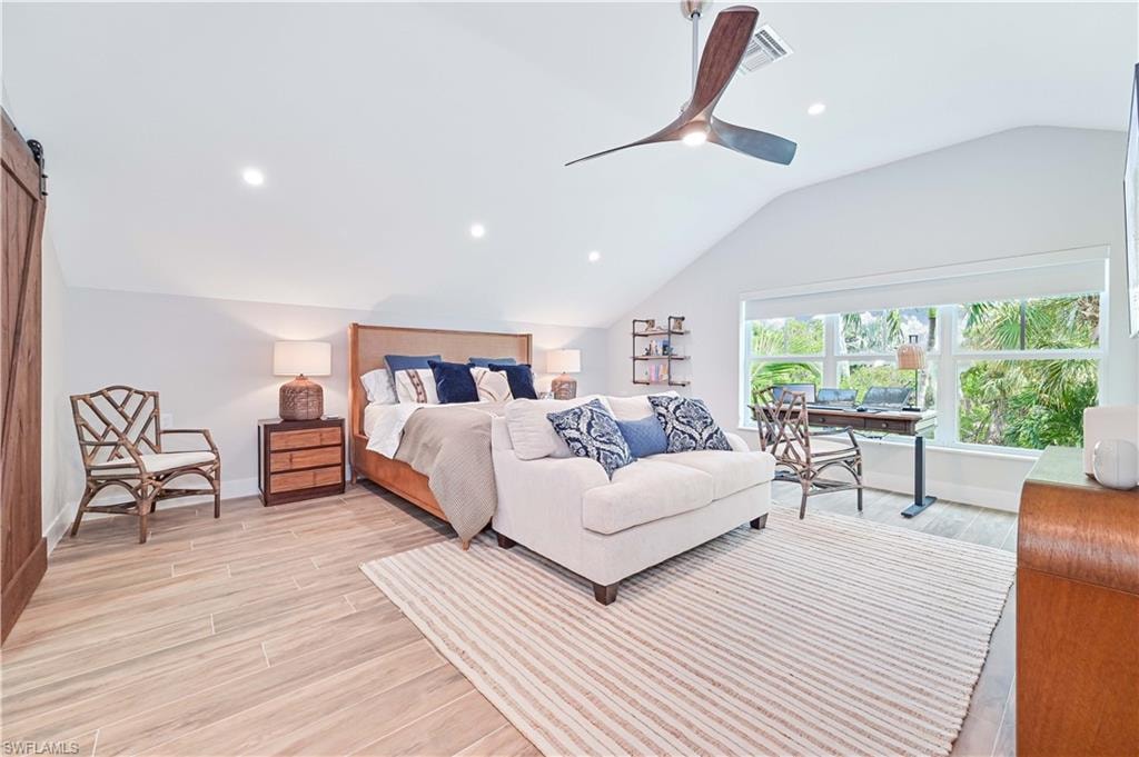 Vaulted ceiling room featuring wood-finish flooring, recessed lighting, and a modern ceiling fan