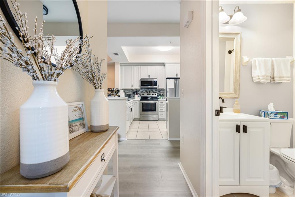 Open concept layout featuring wood-finish flooring extending into the kitchen