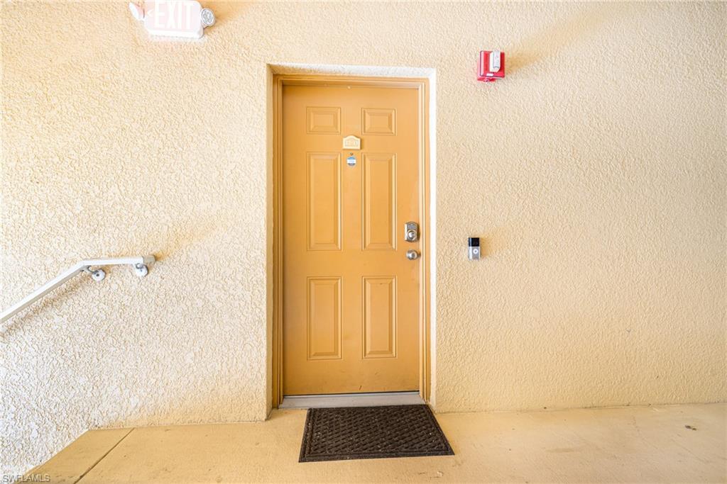 Entry door with panel detailing and a digital lock