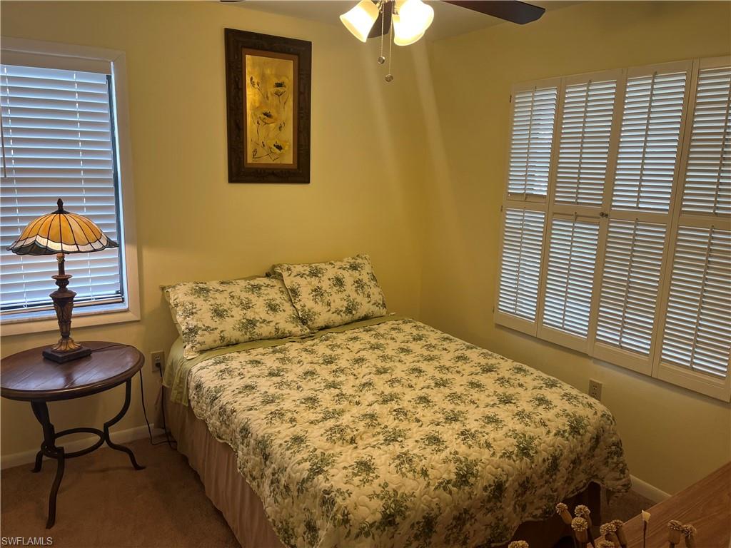Bedroom with carpet, baseboards, and ceiling fan