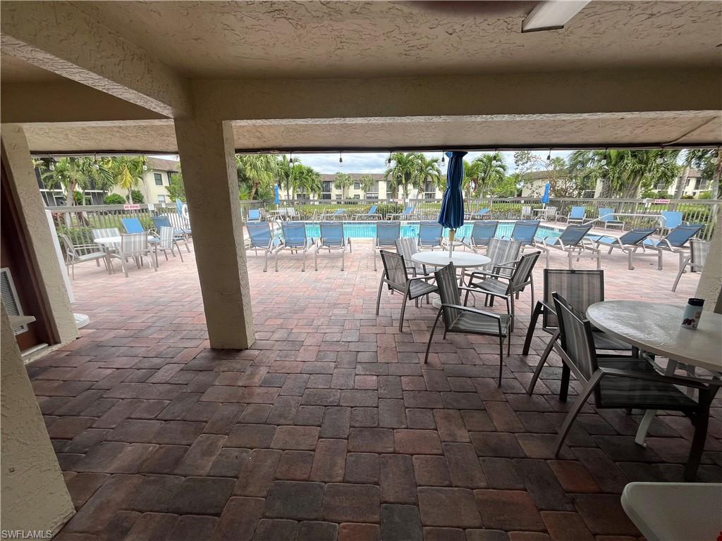 View of patio / terrace with fence and a community pool
