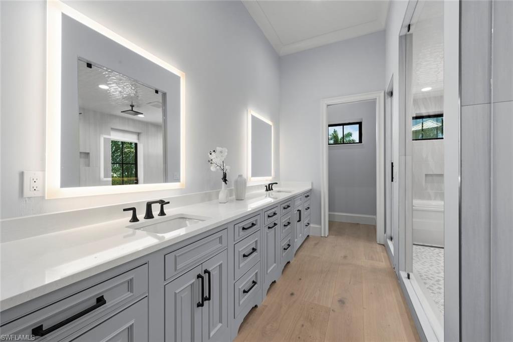WoodMode cabinetry, double sinks, lighted mirrors