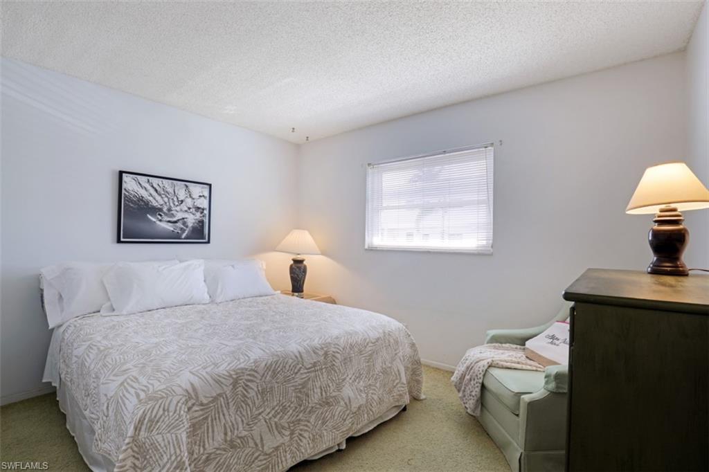 Carpeted bedroom featuring a textured ceiling