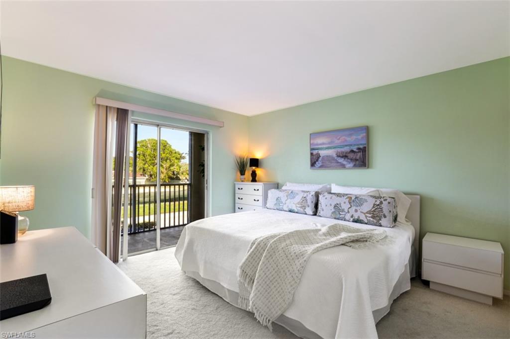 Carpeted bedroom with access to exterior