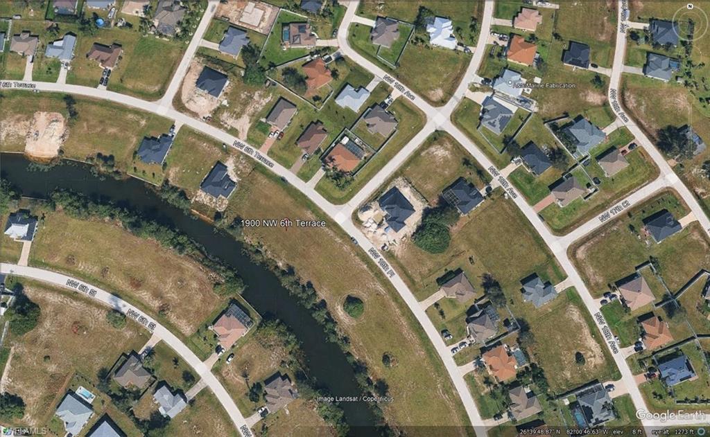 Aerial View of Residential Area. Displaying the property and surrounding structures with street and waterways
