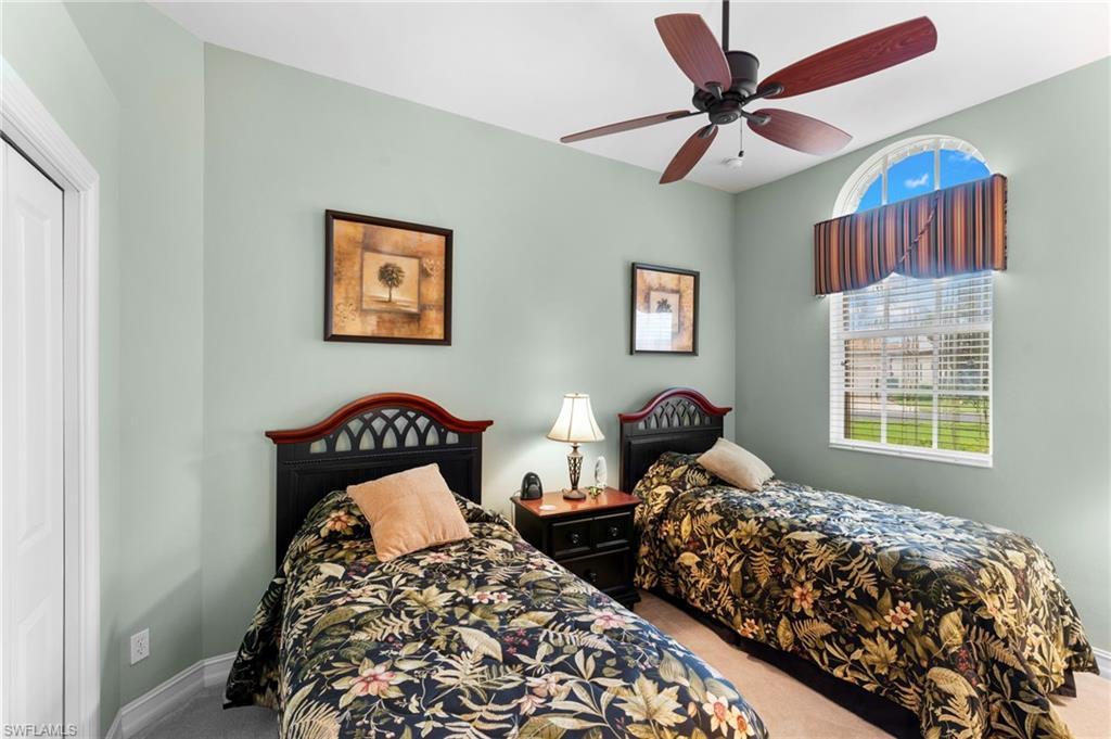 Carpeted bedroom with ceiling fan