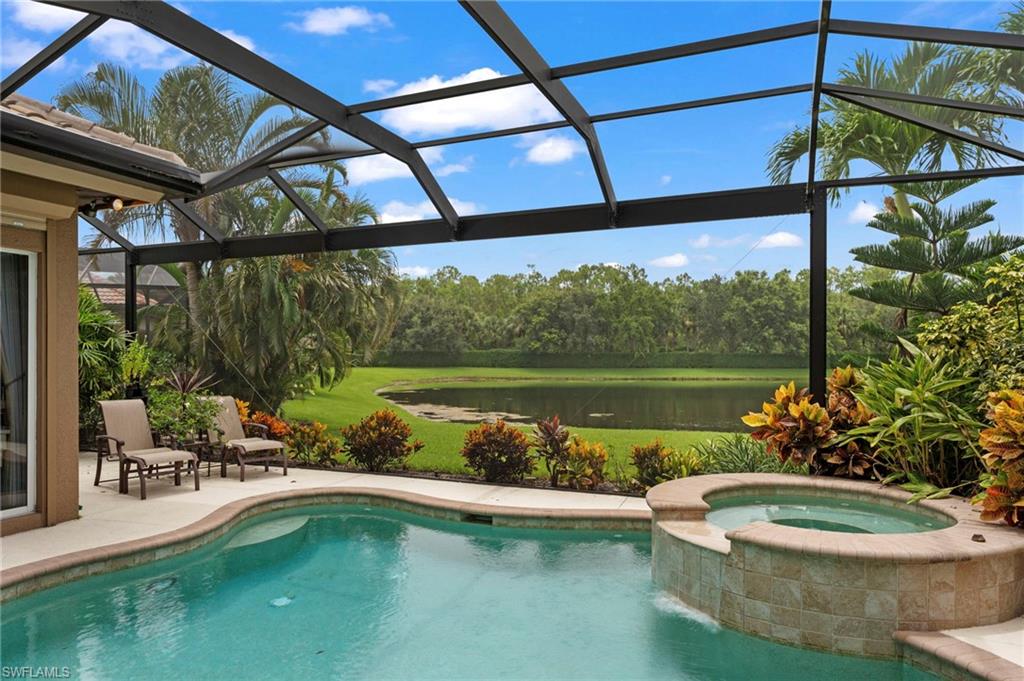 View of swimming pool featuring a patio, an in ground hot tub, and glass enclosure