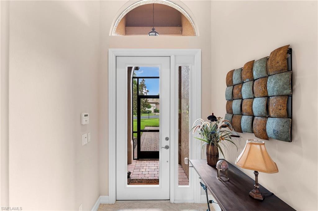 Entryway with light tile patterned floors