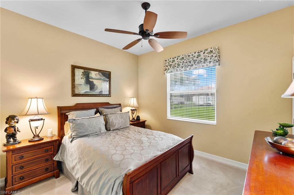 Carpeted bedroom with ceiling fan