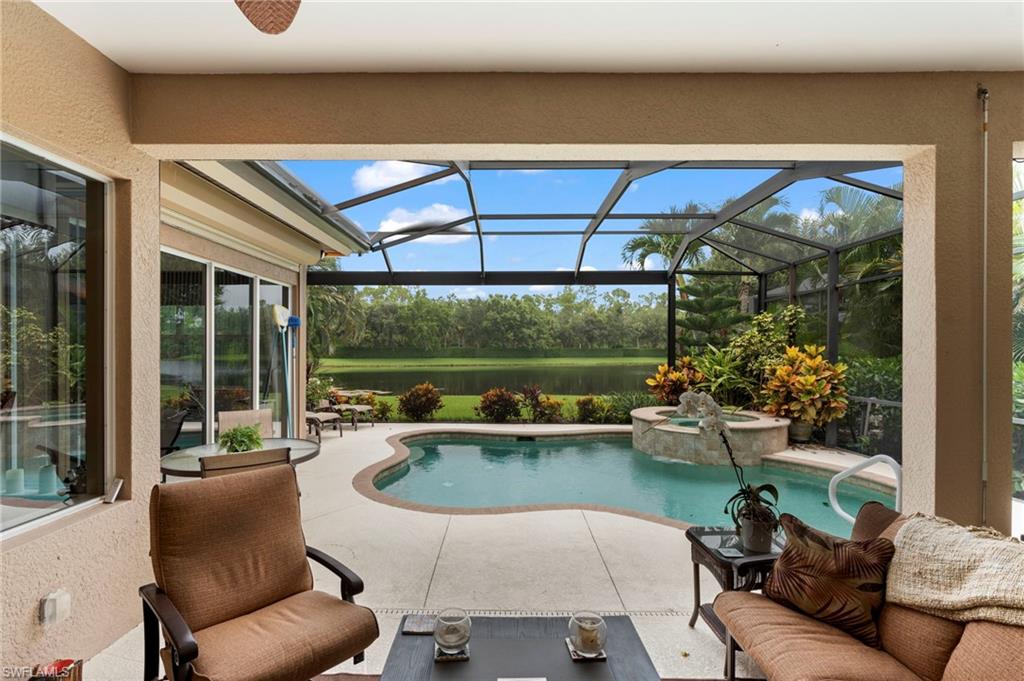 View of swimming pool featuring a patio and glass enclosure