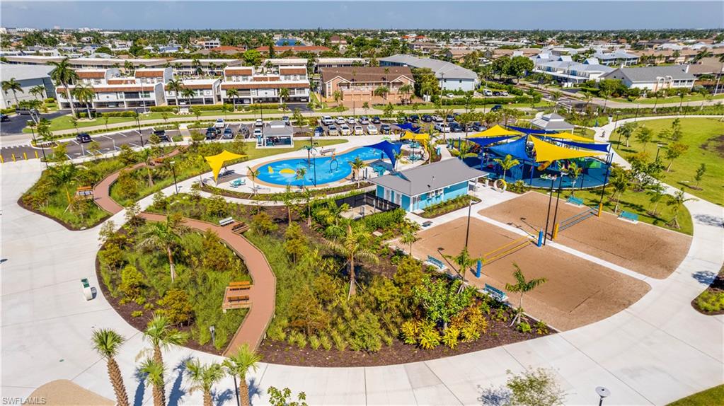 Jaycee Park-Community amenity center featuring a splash pad, multiple shade structures, two sand volleyball courts, and landscaped walking paths