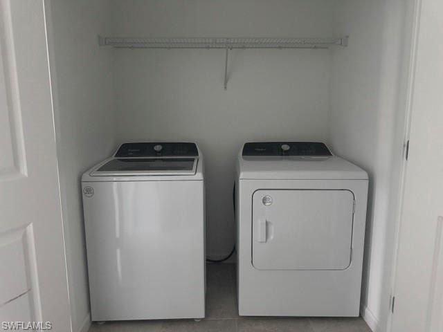 Well-appointed laundry area with included washer and dryer, cabinet storage above, and a clean functional layout — making everyday chores easier in this move-in ready home.