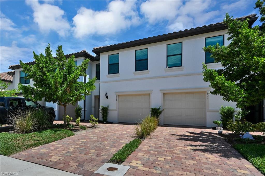 Gorgeous street-view facade of 1519 Lake Jessup with a spacious paver driveway, two-car garage, and manicured landscaping reflecting exceptional pride of ownership.