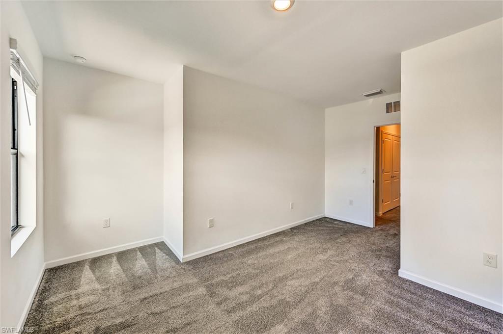 Versatile bedroom with ample square footage, neutral finishes, and natural light — perfect as a guest suite, home office, or additional family bedroom.